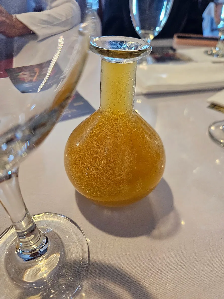A berele flask of amber Ethiopian honey wine on a table at Zagol